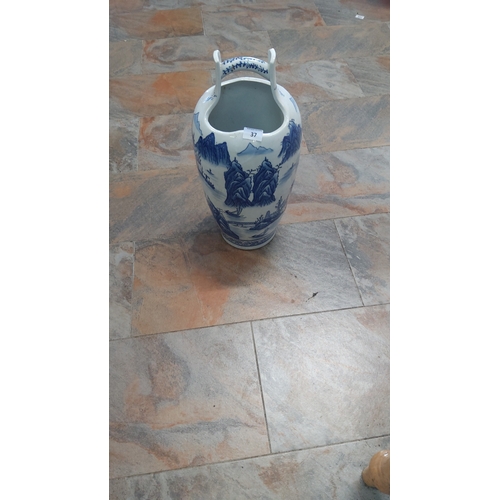 37 - Tall porcelain stick/umbrella stand with yoke-form overhead handle, hand-painted in cobalt landscape... 