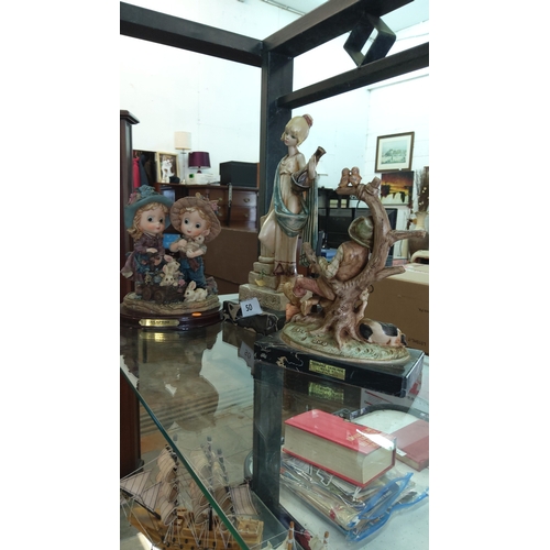 50 - Trio of late-20th-century painted composite figurines comprising: DeCaprio “Boy and Girl with Rabbit... 