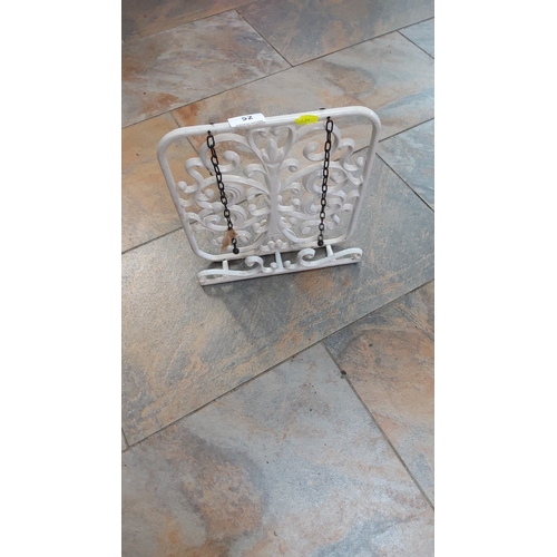 52 - White painted cast-iron cookbook or tablet stand, rectangular scrollwork panel with adjustable page-... 