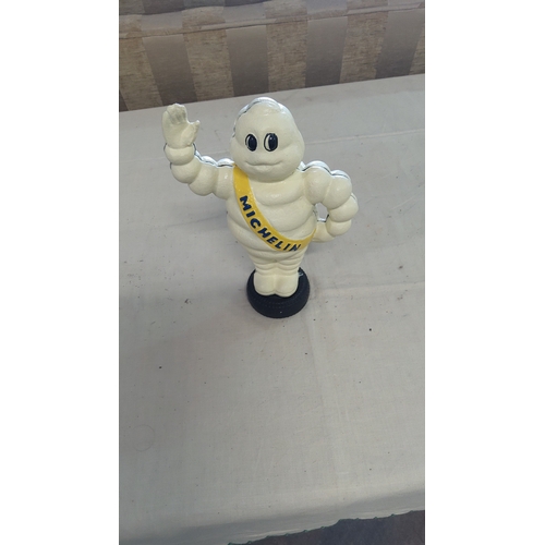 7 - Cast metal figure of the Michelin Man (Bibendum), painted cream with yellow “MICHELIN” sash, raised ... 
