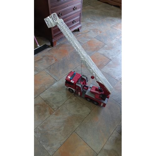107 - Large plastic toy fire engine with six-wheel chassis, extendable white rescue ladder and basket, red... 