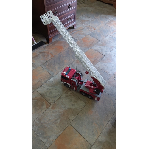 107 - Large plastic toy fire engine with six-wheel chassis, extendable white rescue ladder and basket, red... 