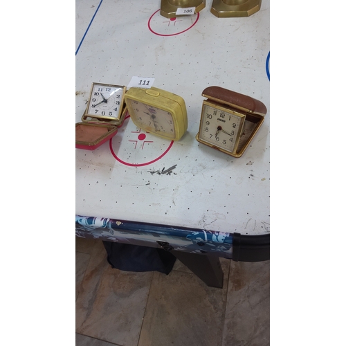 111 - Group of three vintage travel alarm clocks: gilt-framed Equity quartz example, yellow plastic-cased ... 