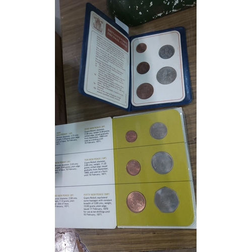 117 - Two Royal Mint wallets, each holding Britain’s six-coin inaugural decimal set—½p, 1p, 2p bronze; 5p,... 