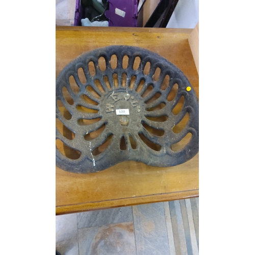 120 - Early 20th-century cast iron tractor seat with pierced oval slats and raised lettering “W E C & Co.”... 