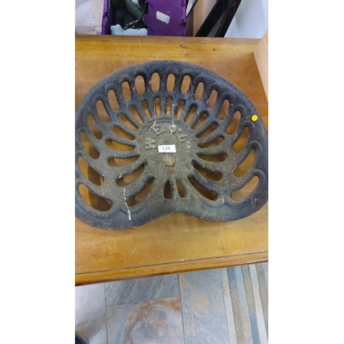 120 - Early 20th-century cast iron tractor seat with pierced oval slats and raised lettering “W E C & Co.”... 