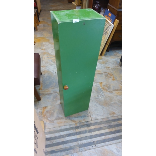 67 - Tall narrow pine cupboard with full-length piano-hinged door, green painted finish, wooden knob hand... 