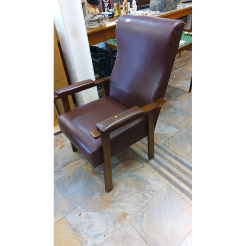 68 - Brown leatherette upholstered high-back armchair with angular hardwood frame and padded armrests, re... 