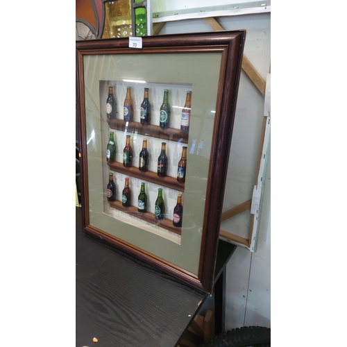 70 - Shadow-boxed display of 15 miniature glass beer bottles with assorted brewery labels, mounted on thr... 