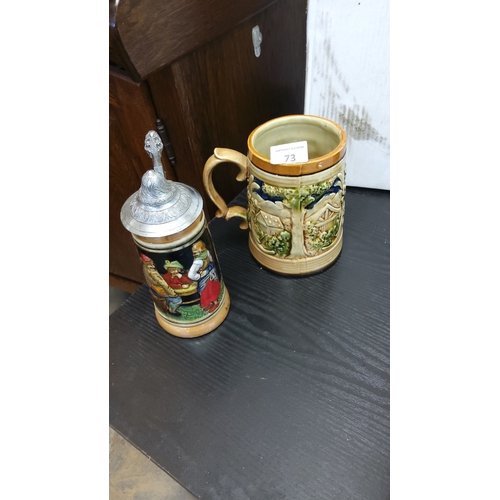 73 - Two German moulded pottery beer steins, one open, one with hinged pewter lid, each with polychrome r... 