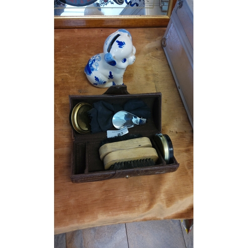 81 - Two-piece lot comprising a hand-painted Delft blue earthenware dog-form piggy bank marked “Handpaint... 