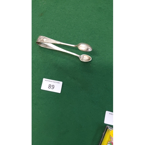 89 - Early 20th-century silver-plated sugar tongs with chased foliate terminals