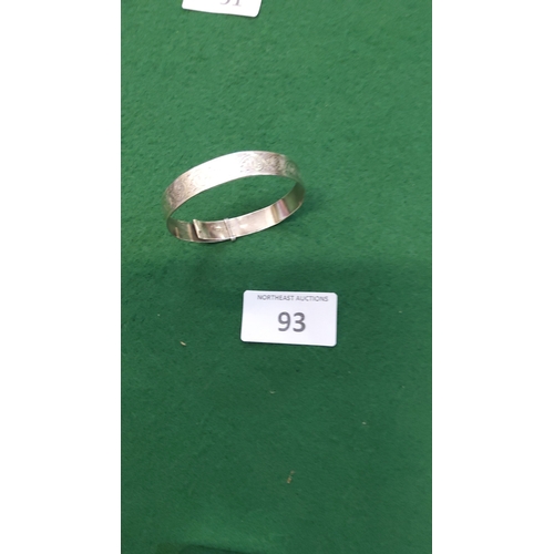 93 - Hinged sterling silver bangle bracelet, the exterior chased with continuous foliate scrolls, stamped... 