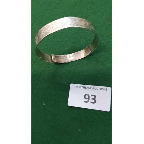 93 - Hinged sterling silver bangle bracelet, the exterior chased with continuous foliate scrolls, stamped... 