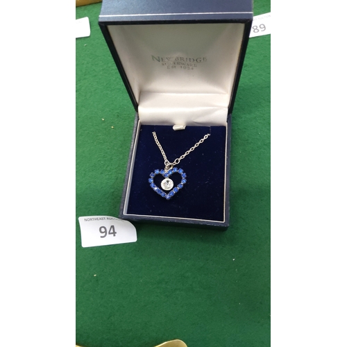 94 - Silver-tone chain necklace with heart-shaped pendant pavé-set with blue crystals and a central clear... 