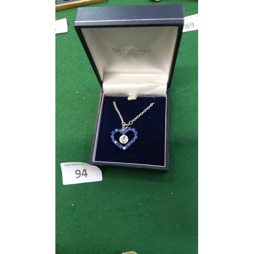 94 - Silver-tone chain necklace with heart-shaped pendant pavé-set with blue crystals and a central clear... 