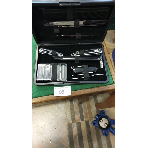 95 - Black cased gentleman’s grooming kit comprising safety razor with spare blades, pocketknife, two nai... 