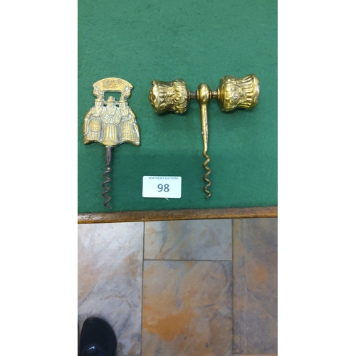 98 - Two gilt-brass corkscrews, one T-handled with twin fluted barrel finials, the other figural showing ... 