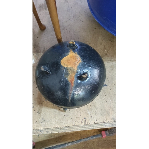 Cast iron three-legged cauldron with banded, rounded body and everted ...