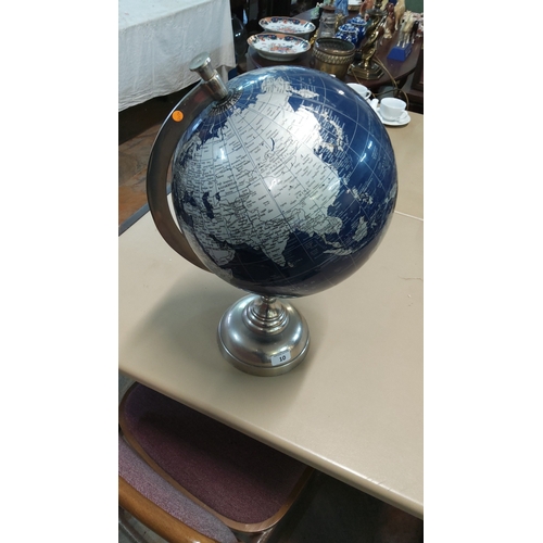 10 - Blue lacquered desktop world globe with silver-tone cartographic detail, set in brushed metal meridi... 