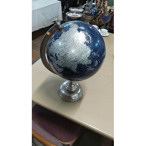 10 - Blue lacquered desktop world globe with silver-tone cartographic detail, set in brushed metal meridi... 