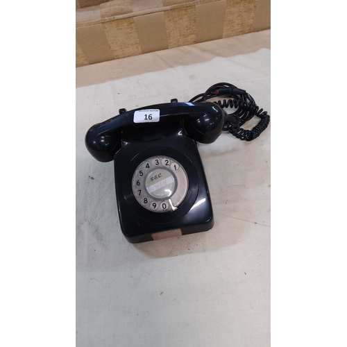 16 - Mid-century G.E.C. black Bakelite rotary desk telephone with numeric dial and coiled handset cord