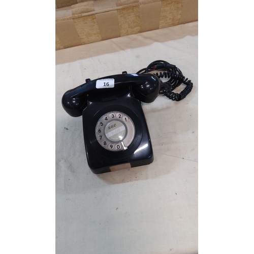 16 - Mid-century G.E.C. black Bakelite rotary desk telephone with numeric dial and coiled handset cord