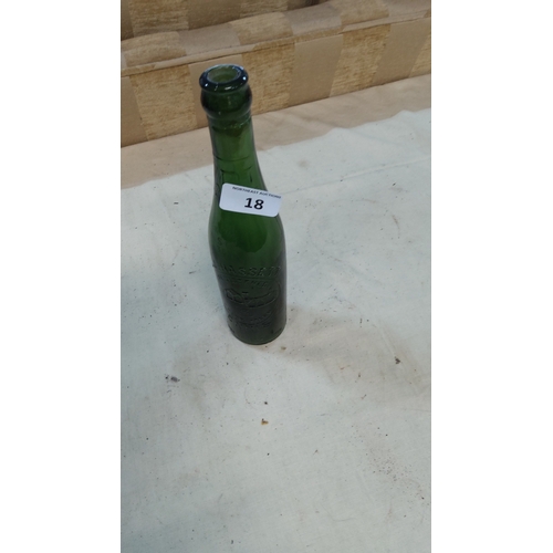 18 - Green glass beer or mineral water bottle embossed with a gothic church motif, legends including “Tra... 