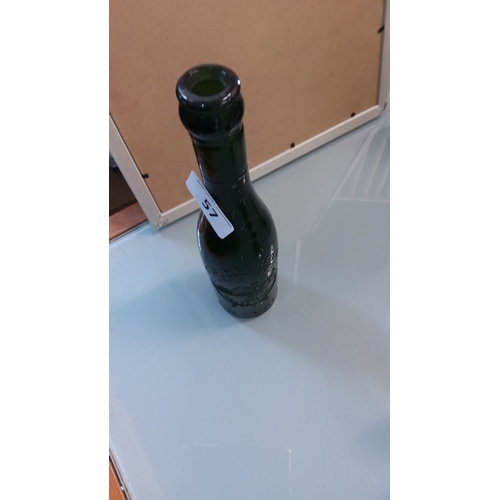 57 - Dark green glass beer bottle with tapered neck, embossed castle vignette, “TRADE MARK ENNIS”
