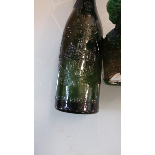 57 - Dark green glass beer bottle with tapered neck, embossed castle vignette, “TRADE MARK ENNIS”