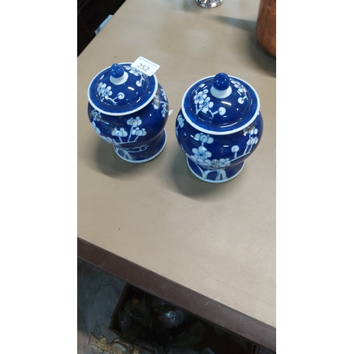 252 - Pair of blue-ground Chinese porcelain covered ginger jars, baluster form, decorated in reserve with ... 