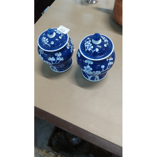 252 - Pair of blue-ground Chinese porcelain covered ginger jars, baluster form, decorated in reserve with ... 