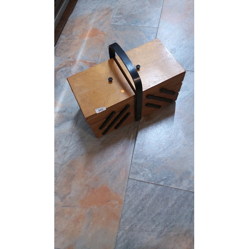 265 - Wooden cantilever sewing or craft box featuring four tiered trays, black metal scissor supports and ... 