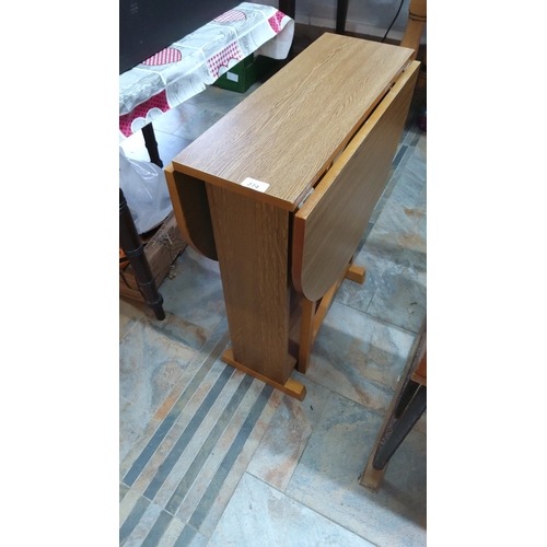 274 - Compact drop-leaf dining table with rectangular central panel and twin semicircular leaves, trestle ... 