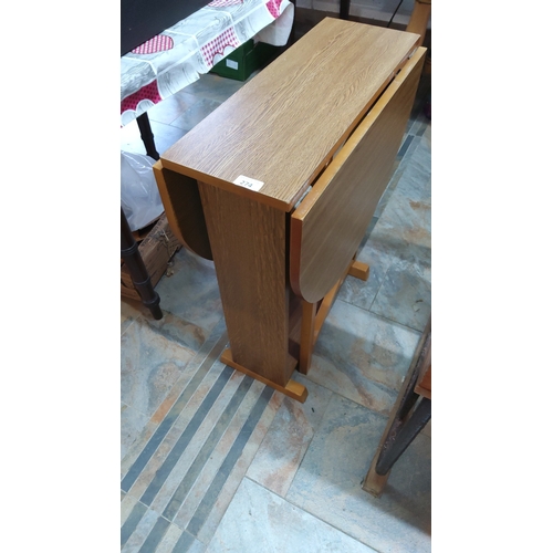 274 - Compact drop-leaf dining table with rectangular central panel and twin semicircular leaves, trestle ... 