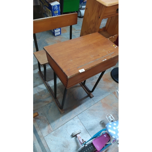 275 - Mid-Century wooden lift-top school desk with integrated bench seat on tubular steel sled base.