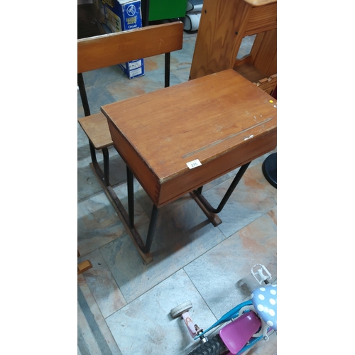 275 - Mid-Century wooden lift-top school desk with integrated bench seat on tubular steel sled base.