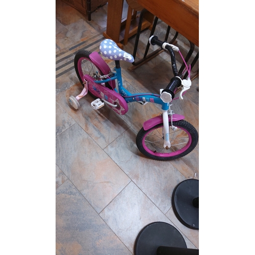 285 - Bright blue and pink children’s 16-inch bicycle with stabilisers, polka-dot saddle, white fork, and ... 