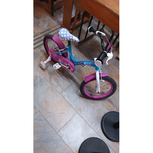 285 - Bright blue and pink children’s 16-inch bicycle with stabilisers, polka-dot saddle, white fork, and ... 