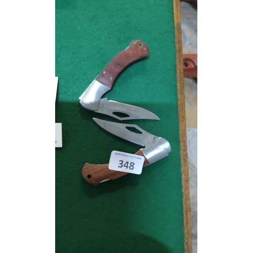 348 - Pair of stainless-steel folding pocket knives, each with clip-point blade and hardwood grip scales s... 