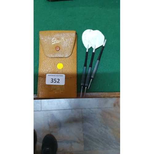 352 - Set of 3 steel-tip darts with ribbed alloy barrels, white flights, and a tan leather snap-closure po... 