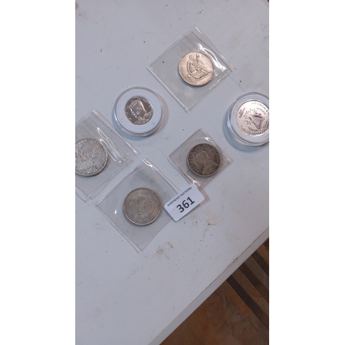 361 - Group of six world silver tone crown-size coins, assorted designs and dates, housed individually in ... 
