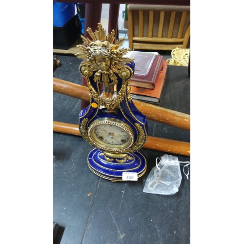 368 - Cobalt blue porcelain lyre mantel clock with gilt metal mounts, sunburst mask finial and Roman dial,... 