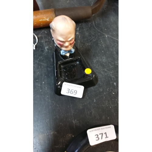 369 - Glazed ceramic triangular ashtray surmounted by a caricature bust of Winston Churchill in bow tie, B... 