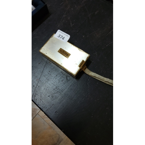 374 - Gold-tone rectangular vanity compact with integral mirror, twin powder compartments, lipstick holder... 
