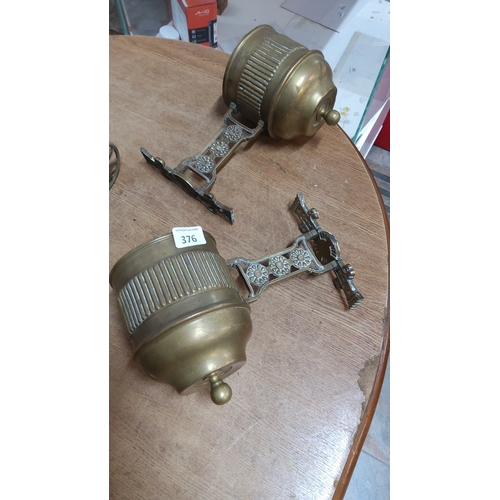 376 - Pair of Victorian cast brass wall-mounted swivel sconces, each with reeded cylindrical nozzle, turne... 