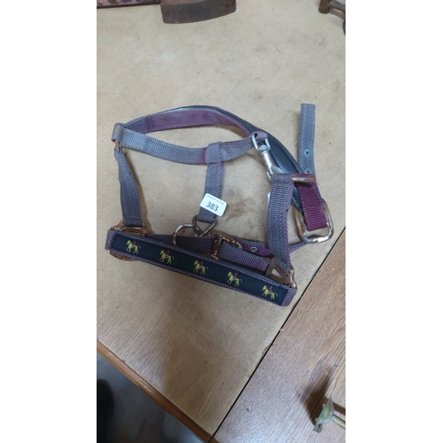 383 - Nylon webbing horse headcollar with brass-tone fittings and padded noseband decorated with repeating... 