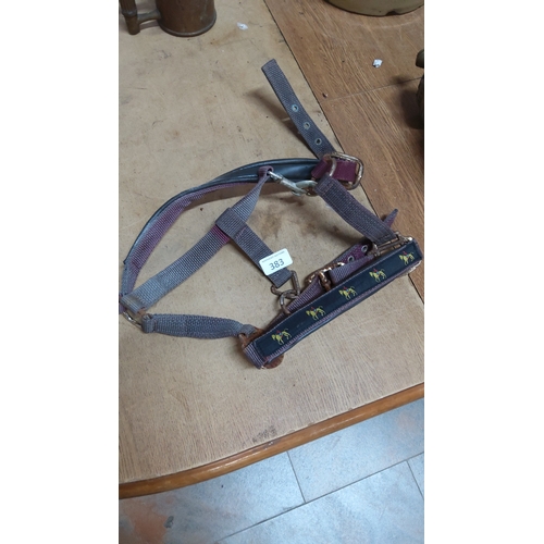 383 - Nylon webbing horse headcollar with brass-tone fittings and padded noseband decorated with repeating... 