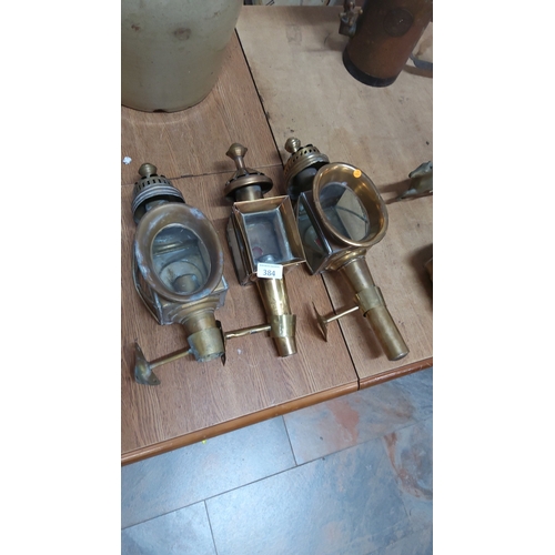 384 - Set of three brass coach lanterns with glass panels and mounting brackets, late 19th/early 20th cent... 