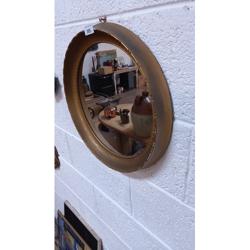 385 - Circular giltwood convex mirror with moulded rim and beaded inner slip, 20th century.